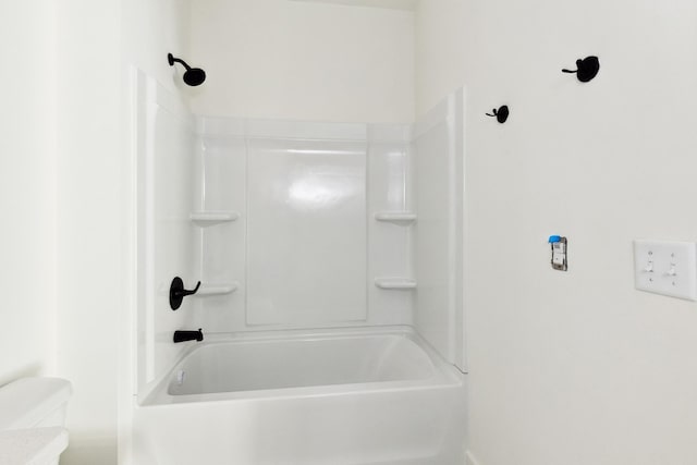 bathroom featuring walk in shower and toilet