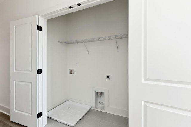 laundry area with laundry area, baseboards, washer hookup, light tile patterned floors, and hookup for an electric dryer