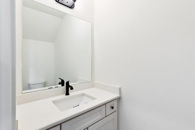 bathroom featuring toilet and vanity