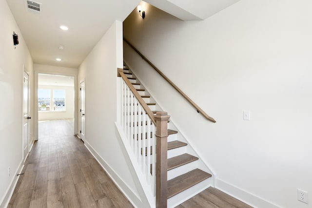 stairs featuring visible vents, recessed lighting, baseboards, and wood finished floors