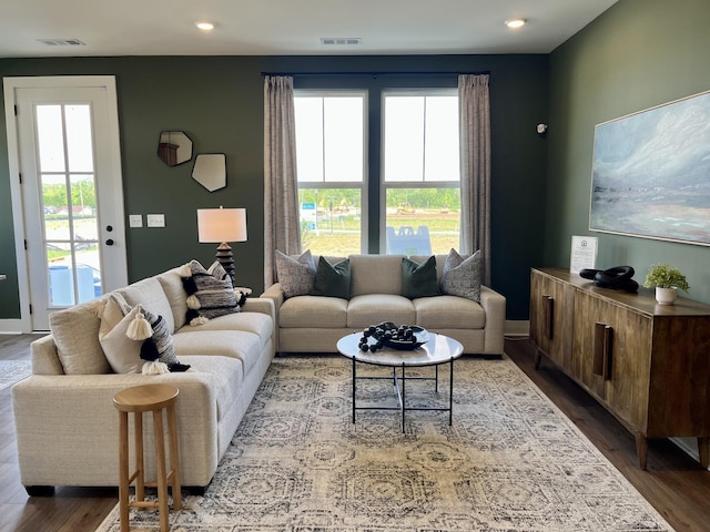 living area with recessed lighting, dark wood-style flooring, and visible vents