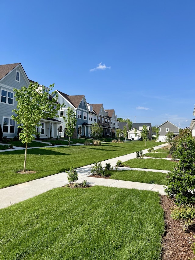 view of community with a lawn and a residential view