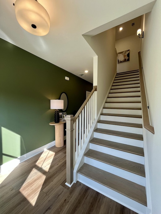 staircase with recessed lighting, baseboards, visible vents, and wood finished floors