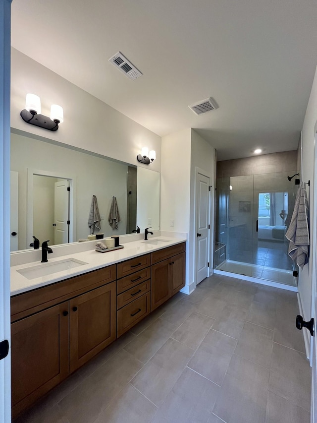bathroom with visible vents, a shower stall, a sink, and tile patterned flooring