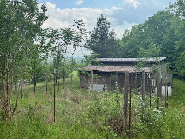 view of outbuilding with a view of trees