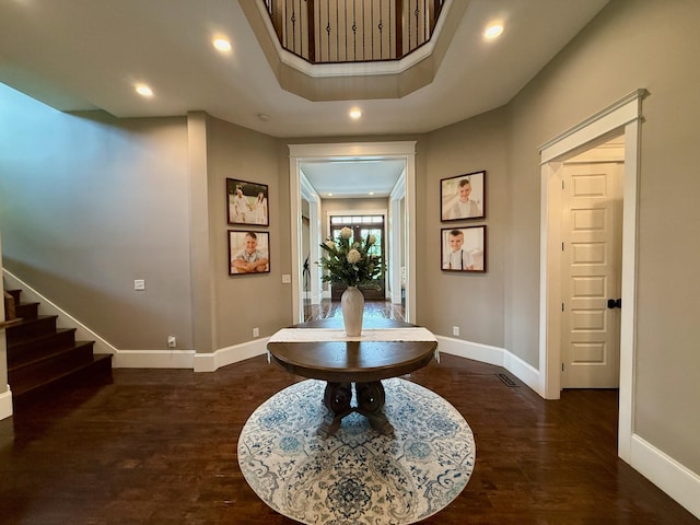 foyer featuring recessed lighting, baseboards, wood finished floors, and stairway