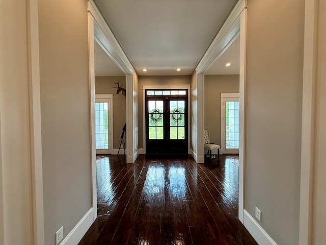 foyer featuring dark wood-type flooring, recessed lighting, baseboards, and french doors