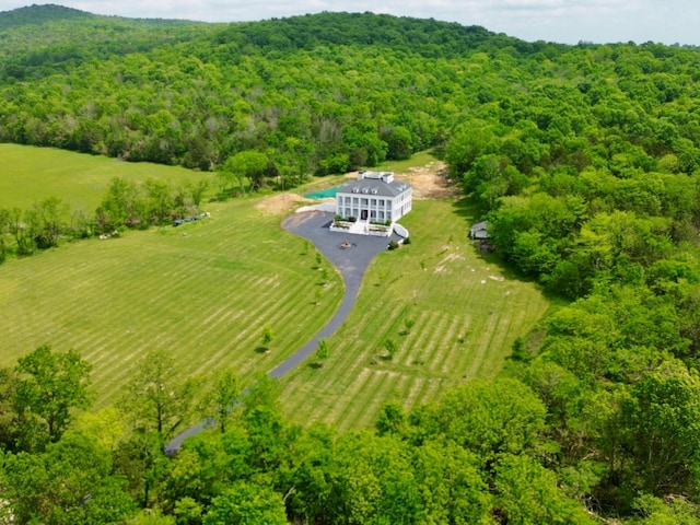 birds eye view of property with a view of trees and a rural view