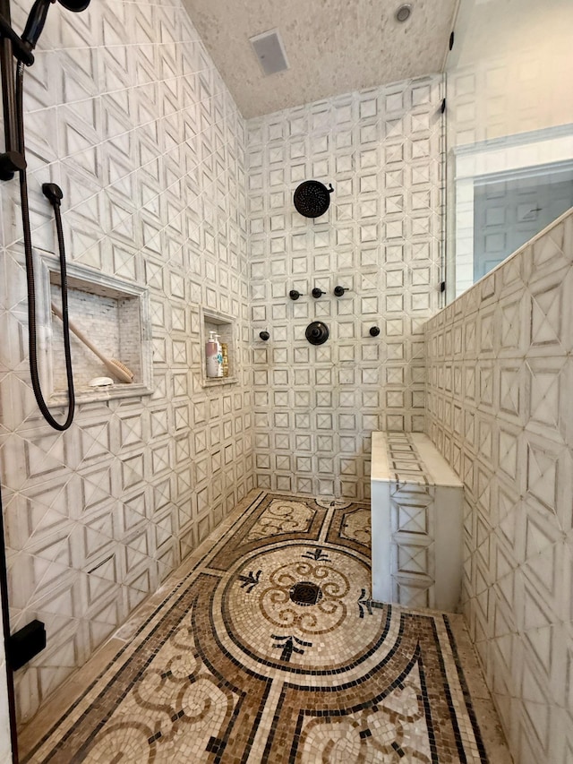 full bath featuring a tile shower