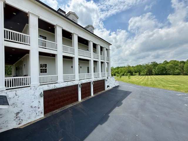 view of building exterior with aphalt driveway