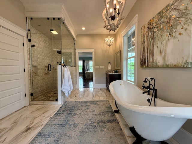 ensuite bathroom with an inviting chandelier, a freestanding bath, ensuite bath, marble finish floor, and a shower stall