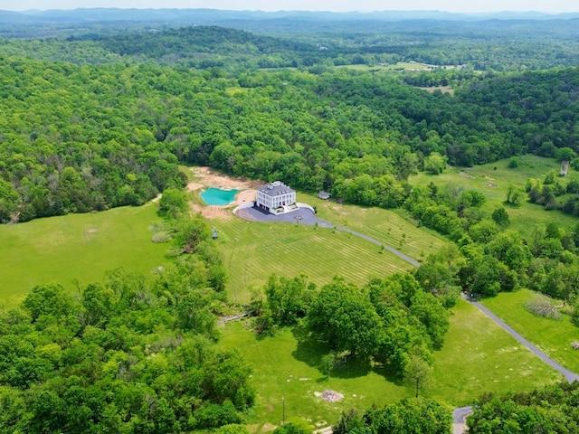 drone / aerial view featuring a forest view and a rural view
