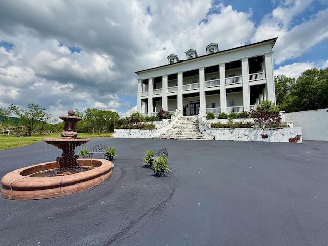 view of front of property with a porch and a balcony