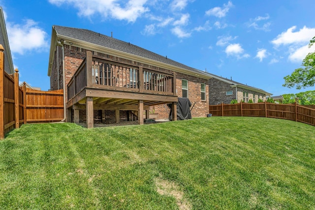 back of property featuring a lawn, brick siding, and a fenced backyard