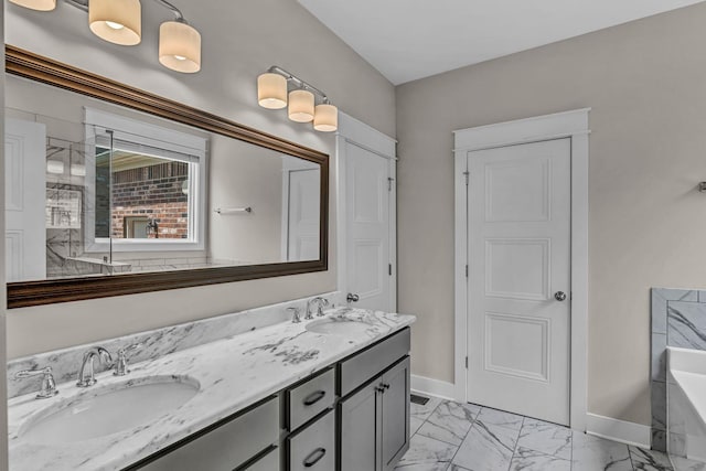 full bathroom with baseboards, a sink, marble finish floor, and a bath