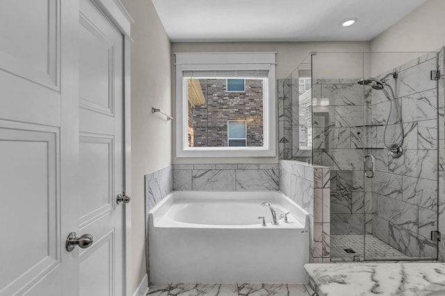 bathroom featuring marble finish floor, baseboards, recessed lighting, a bath, and a shower stall