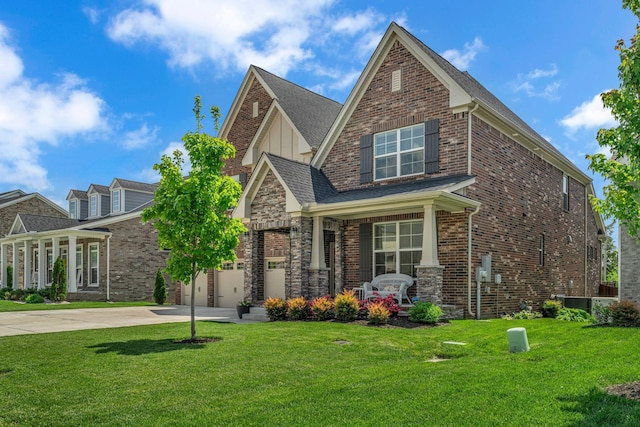 view of front of property with board and batten siding, driveway, a front yard, and covered porch