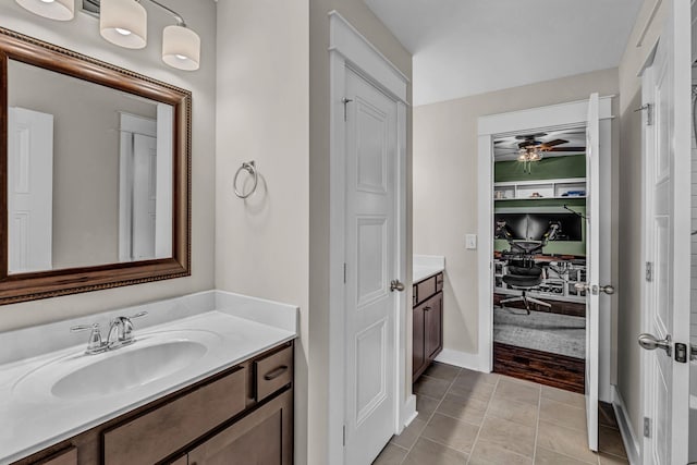 bathroom featuring a ceiling fan, tile patterned floors, baseboards, and vanity