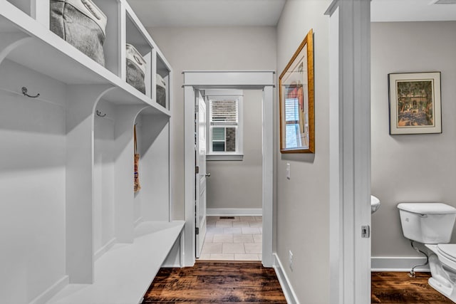 mudroom featuring baseboards and dark wood finished floors