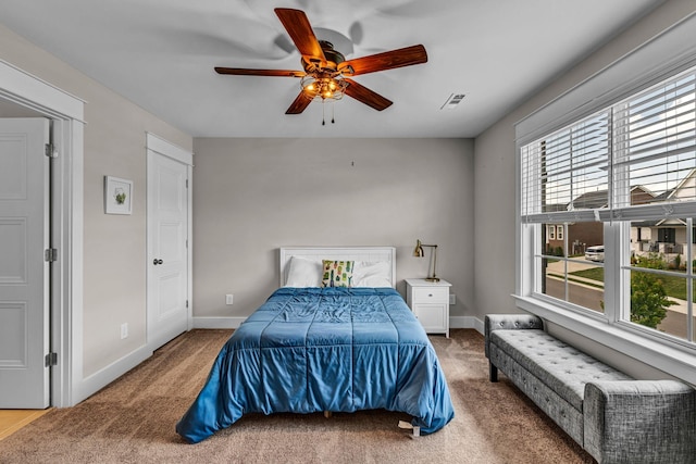 bedroom featuring baseboards, carpet, a ceiling fan, and visible vents