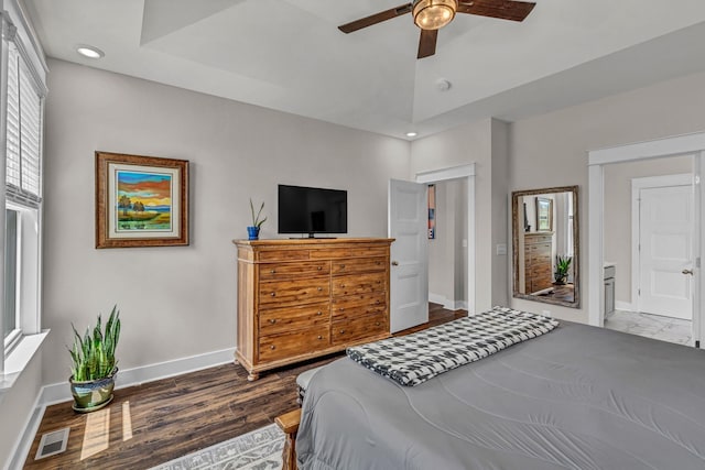 bedroom with visible vents, baseboards, dark wood-style floors, and multiple windows