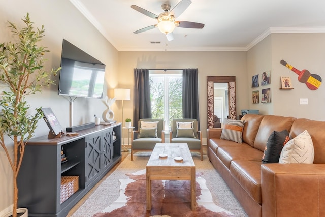 living room featuring ornamental molding, a ceiling fan, and visible vents