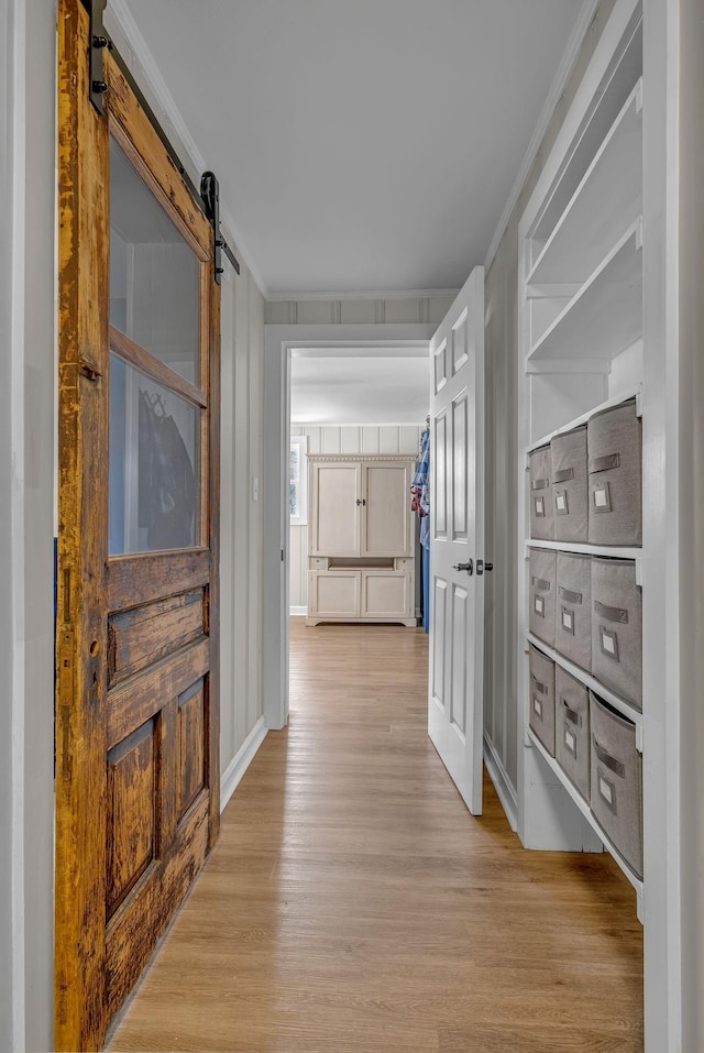 2075 Buttrey Rd, Bon Aqua, TN 37025 - hall featuring crown molding, a barn door, and light wood-style floors