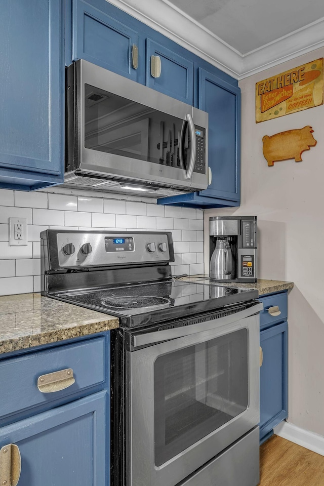 2075 Buttrey Rd, Bon Aqua, TN 37025 - kitchen featuring decorative backsplash, ornamental molding, stainless steel appliances, and blue cabinetry