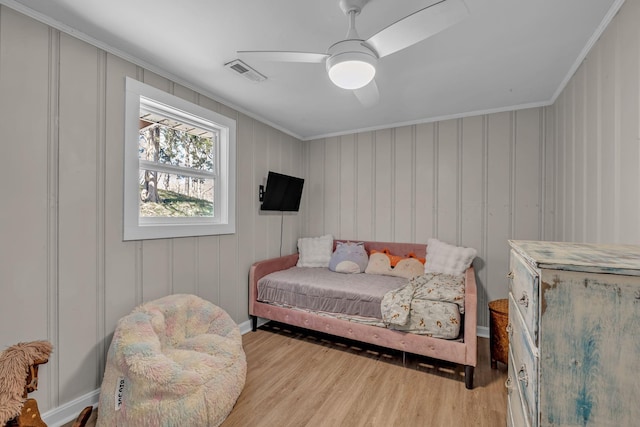 2075 Buttrey Rd, Bon Aqua, TN 37025 - bedroom with visible vents, crown molding, a decorative wall, light wood-style floors, and ceiling fan