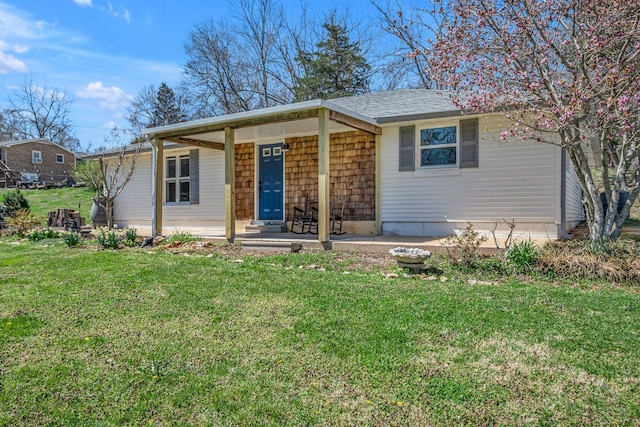 2075 Buttrey Rd, Bon Aqua, TN 37025 - view of front facade featuring roof with shingles, a porch, and a front yard
