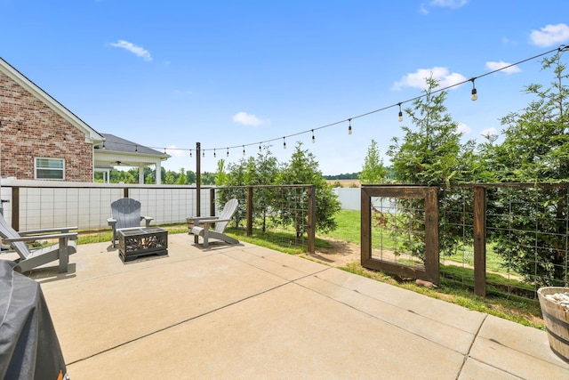 view of patio with a water view, a fire pit, and fence
