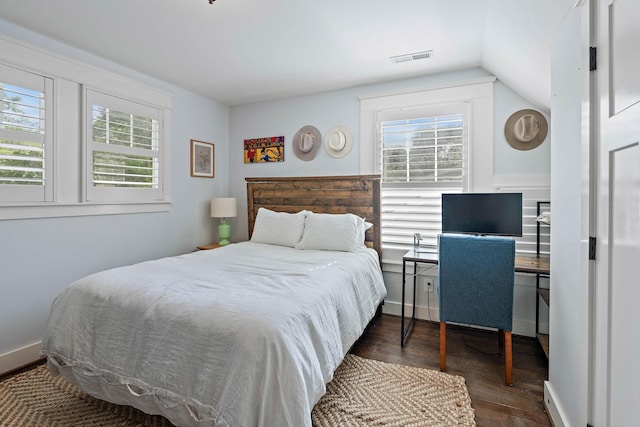bedroom featuring visible vents, vaulted ceiling, dark wood-style floors, and multiple windows