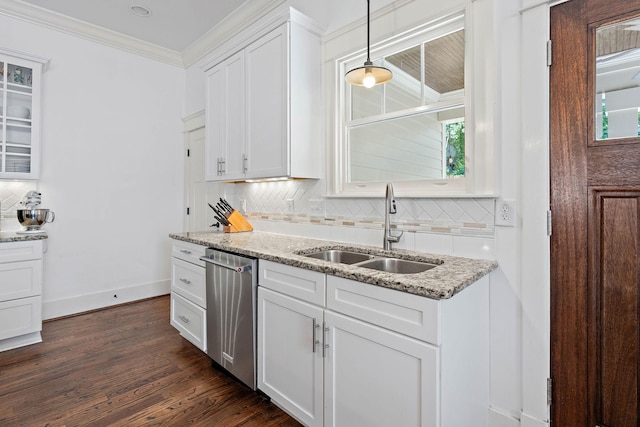 kitchen featuring white cabinets, crown molding, a sink, decorative backsplash, and stainless steel dishwasher