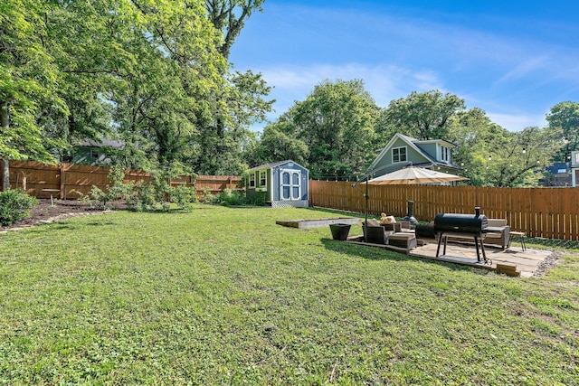 view of yard with a fenced backyard, an outbuilding, an outdoor living space, and a storage shed