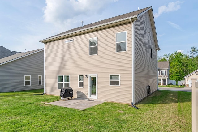 rear view of property with a yard and a patio