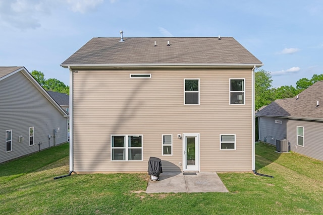 rear view of property featuring a patio, central AC unit, a lawn, and a shingled roof