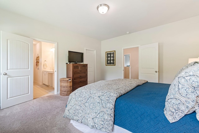 bedroom with carpet floors and ensuite bathroom