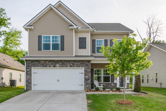 craftsman-style house featuring a garage, concrete driveway, a front lawn, and stone siding