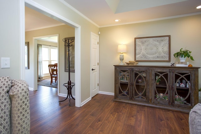 corridor featuring baseboards, ornamental molding, recessed lighting, and wood finished floors