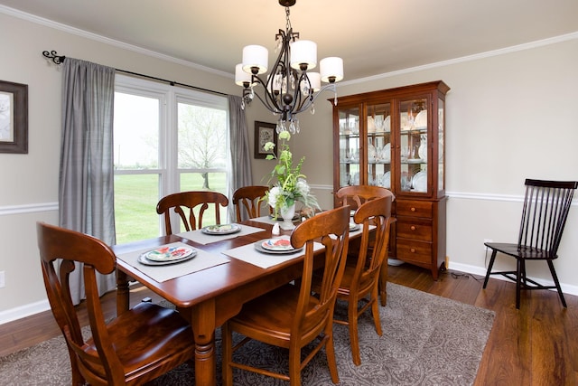 dining area featuring crown molding, baseboards, a notable chandelier, and dark wood-type flooring