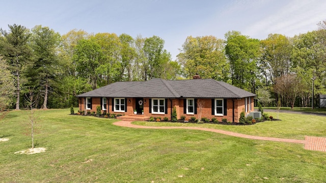ranch-style house with brick siding, central AC unit, a front lawn, and a chimney