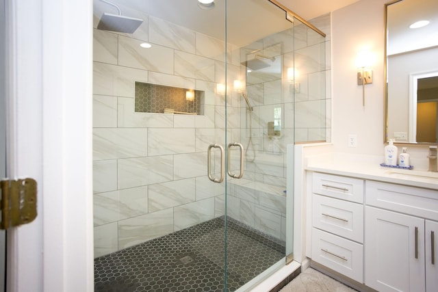 bathroom featuring vanity, recessed lighting, and a stall shower