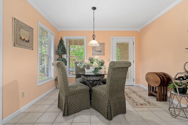 dining room with light tile patterned floors, baseboards, and ornamental molding