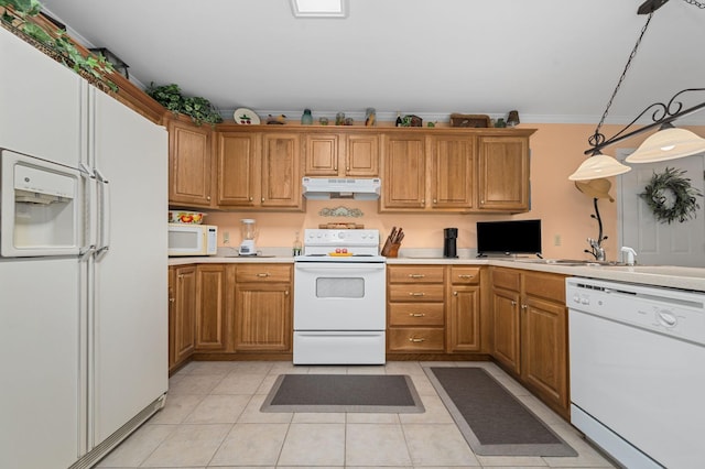 kitchen featuring white appliances, under cabinet range hood, brown cabinetry, and light countertops