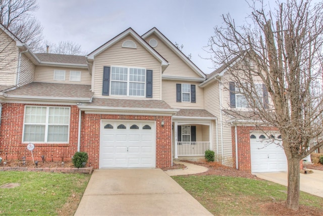 traditional-style house with a shingled roof, an attached garage, driveway, and brick siding