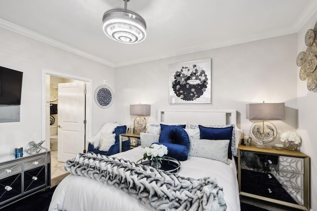 bedroom with ornamental molding and ensuite bath