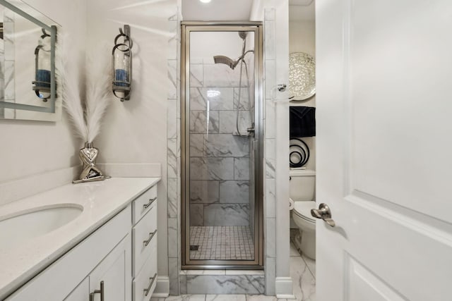 full bathroom with vanity, marble finish floor, toilet, and a shower stall