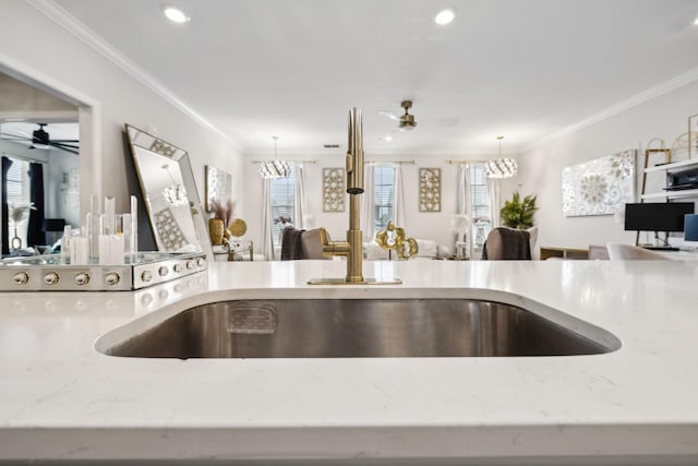room details with crown molding, a ceiling fan, decorative light fixtures, and light stone countertops