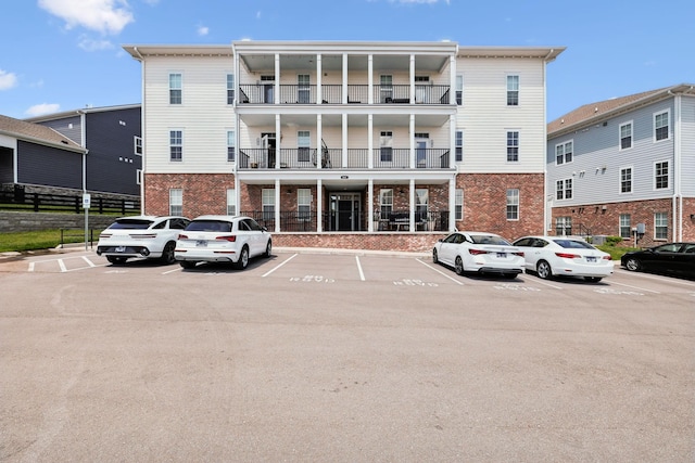 view of property featuring fence and uncovered parking