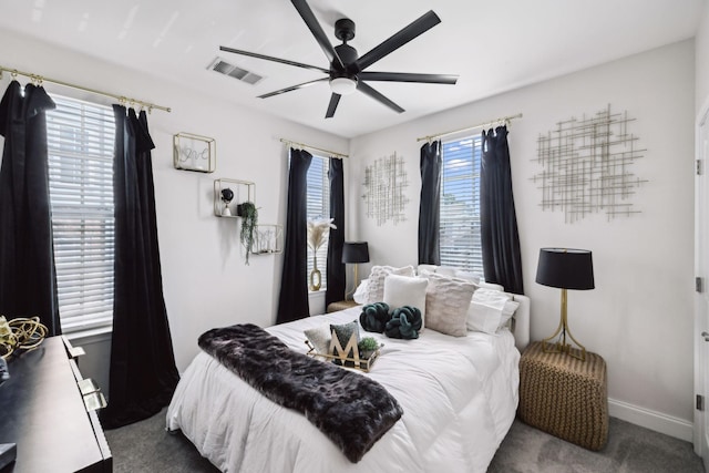 carpeted bedroom with baseboards, ceiling fan, and visible vents